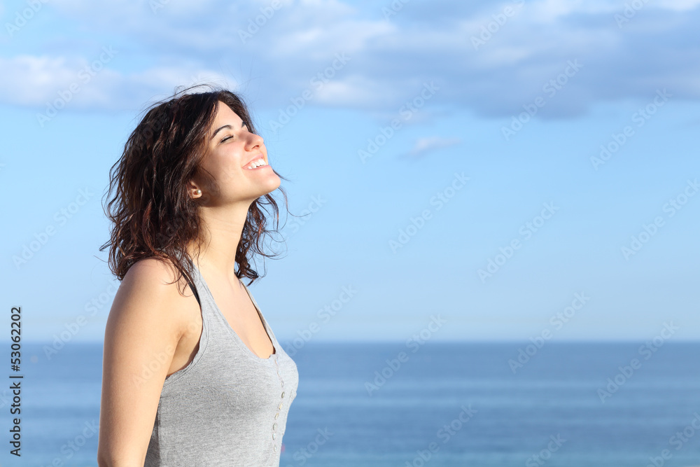 Beautiful girl breathing and smiling on the beach Beautiful girl breathing and smiling on the beach