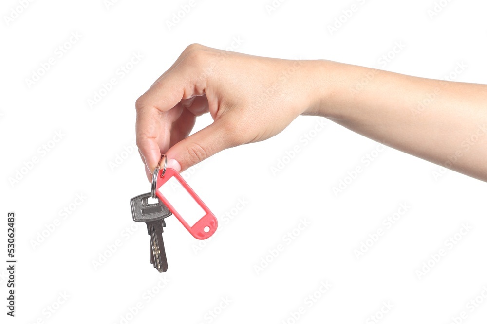 Side view of a woman hand giving a house keys Side view of a woman hand giving a house keys