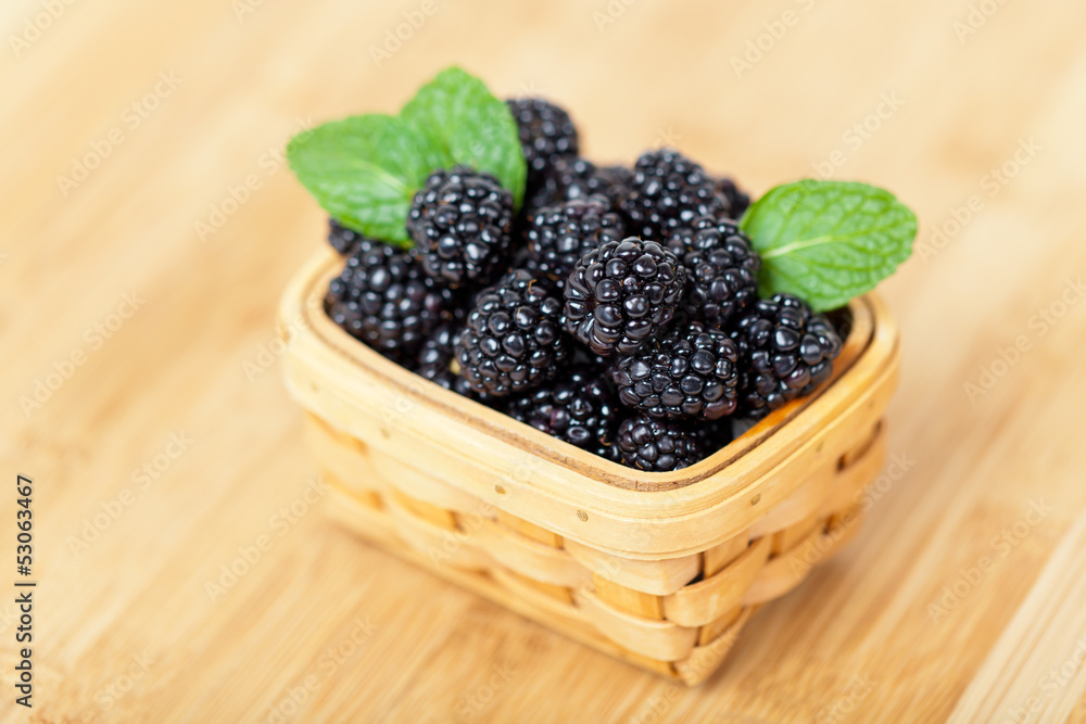 Fresh Blackberries in basket on white Fresh Blackberries in basket on white