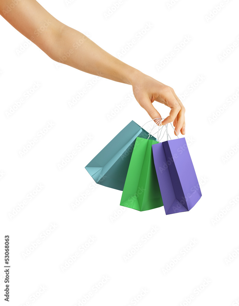 Hand with color shopping bags on white background