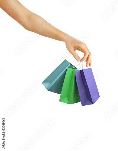 Hand with color shopping bags on white background