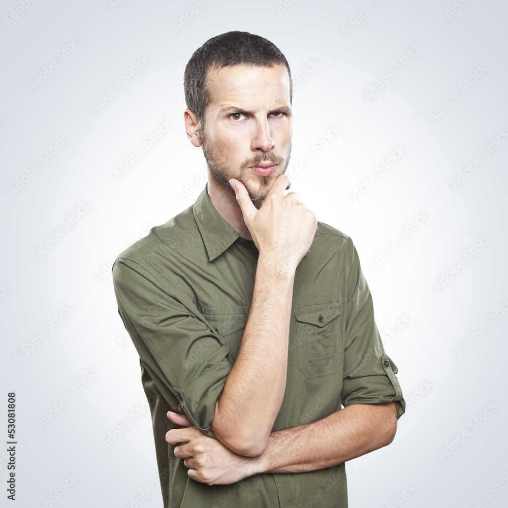 Portrait of handsome young thoughtful man isolated over white ba Portrait of handsome young thoughtful man isolated over white ba
