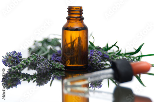 Fototapeta Naklejka Na Ścianę i Meble -  Essential oil bottle with lavender flowers and rosemary