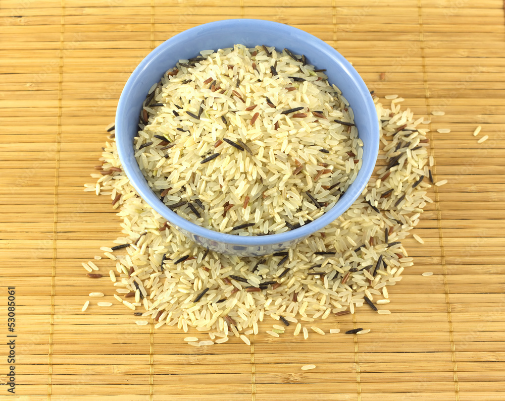 China color rice in blue bowl on brown straw mat closeup China color rice in blue bowl on brown straw mat closeup