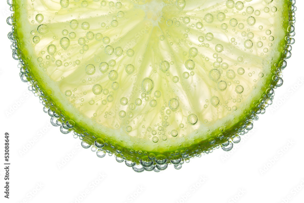Lime Slice in Clear Fizzy Water Bubble Background Stock Photo | Adobe Stock