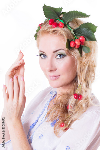 Sensual woman with wreath from cherry and leaves