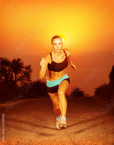 Sporty woman running on sunset © Anna Om