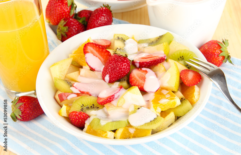 Useful fruit salad of fresh fruits and berries in bowl