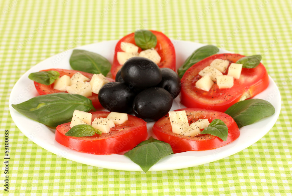 Cheese mozzarella with vegetables in plate on table Cheese mozzarella with vegetables in plate on table