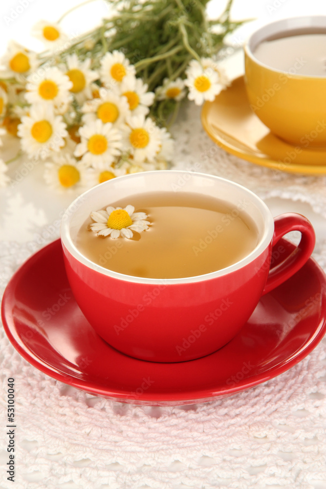 Cups of herbal tea with camomiles close up Cups of herbal tea with camomiles close up