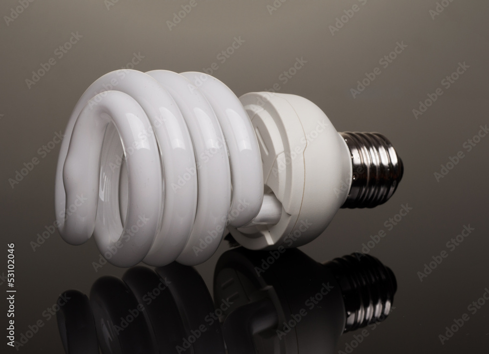 Eco light bulb at black background with reflection Eco light bulb at black background with reflection