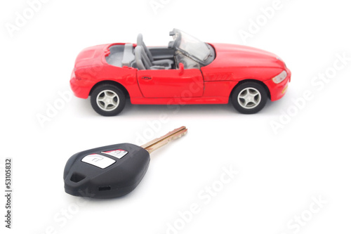 key and toy red car on white background