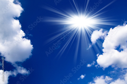 Blue sky with clouds and sun. White clouds in blue sky