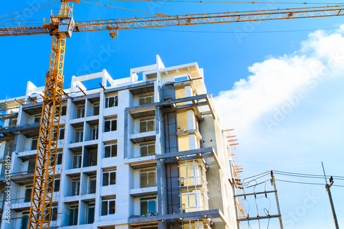 Apartments construction site with yellow crane