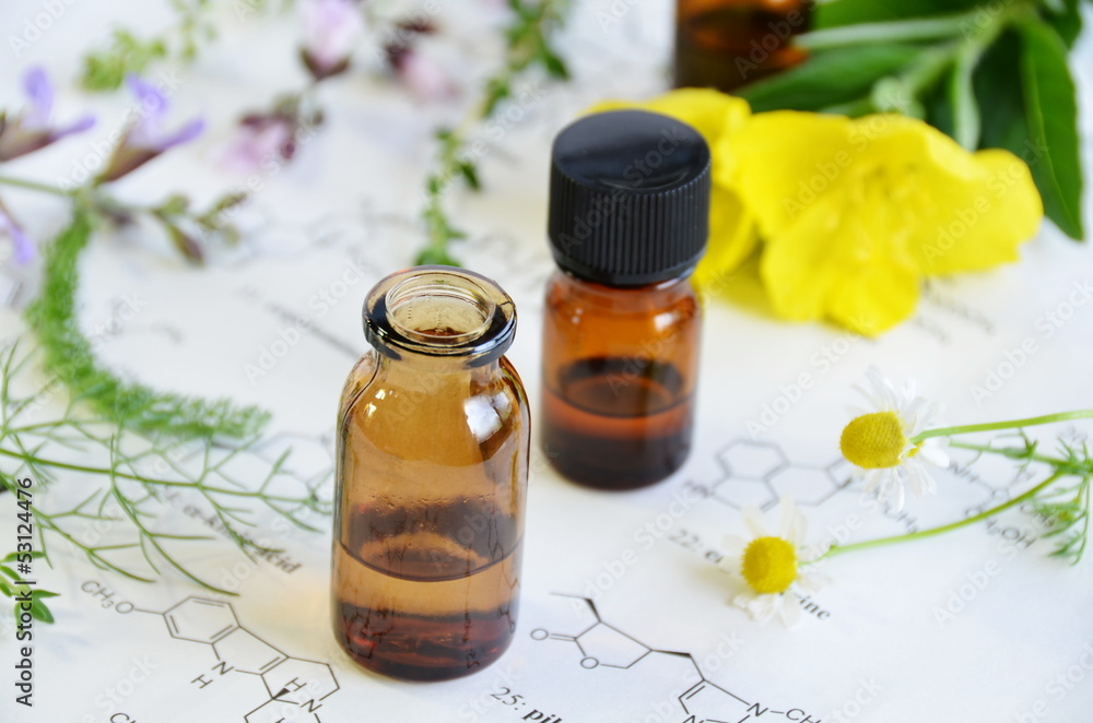 essential oils with herbal flowers on science sheet essential oils with herbal flowers on science sheet