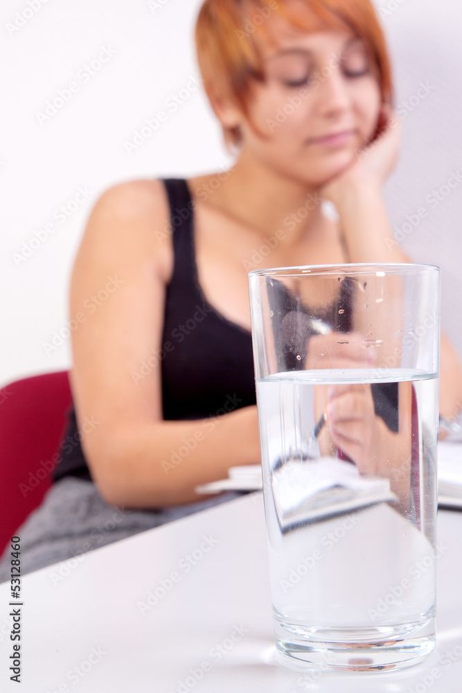 young business woman with water glass on the desk young business woman with water glass on the desk