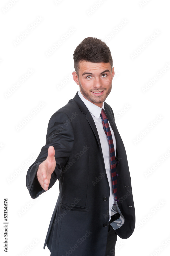 Dynamic happy businessman proffering a handshake Dynamic happy businessman proffering a handshake