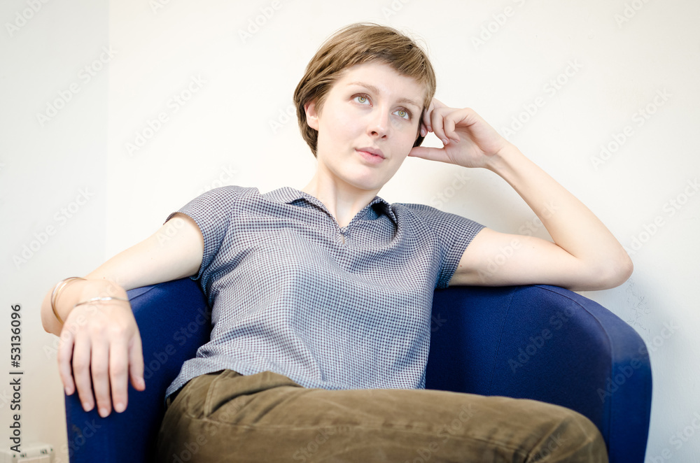 young beautiful hipster woman sitting in the armchair young beautiful hipster woman sitting in the armchair