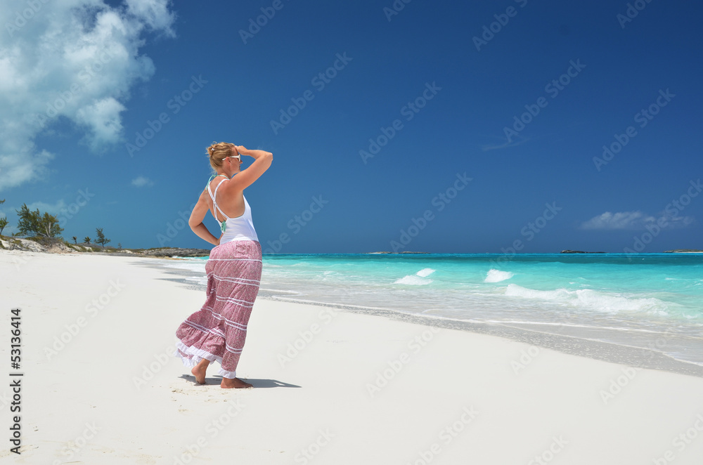 Girl on the desrt beach. Exuma, Bahamas