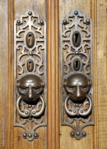 Door knockers with ornamental escutcheons in Lisbon, Portugal photo