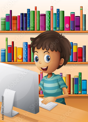 A boy using the computer inside the library photo