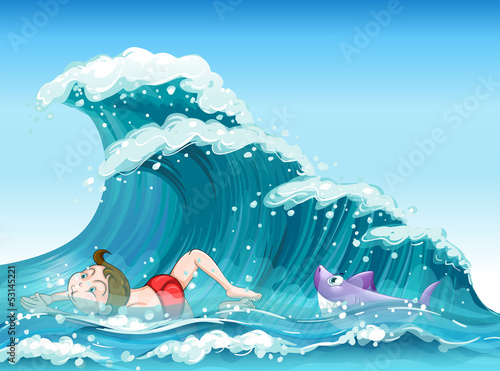 A boy swimming with a shark at the back