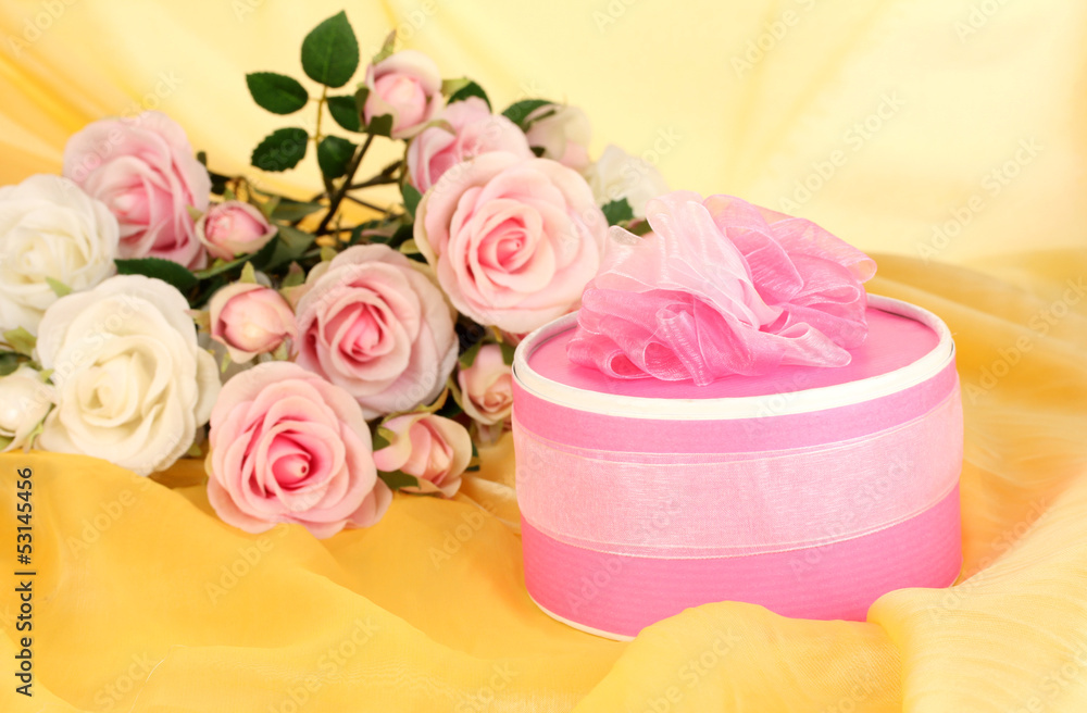 Beautiful gift on flowers background