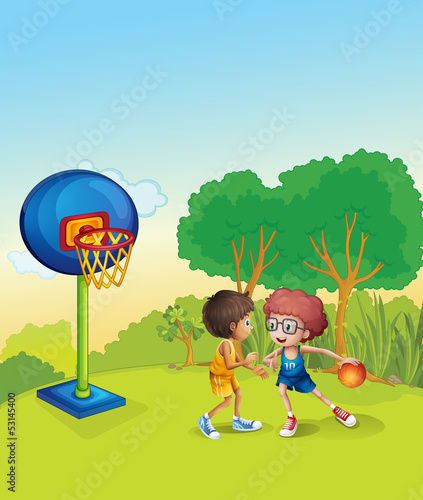Boys playing basketball at the top of the hill