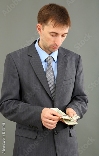 Young businessman with mone...