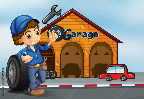 A boy standing in front of a garage