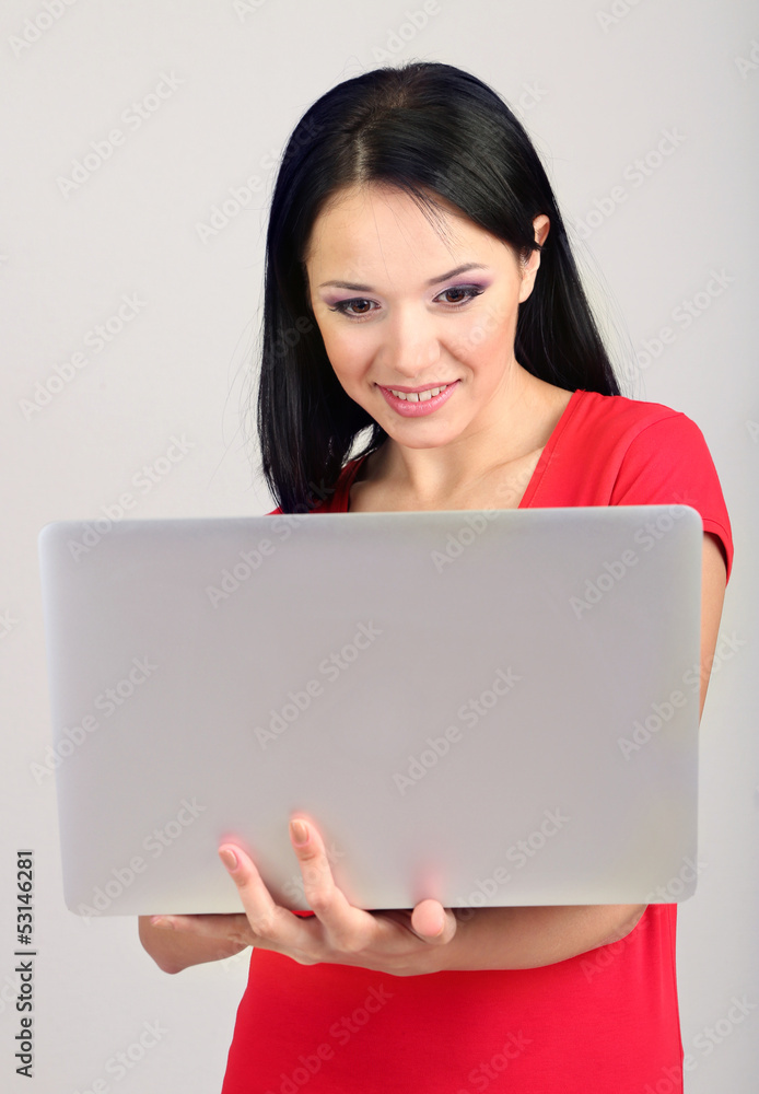 Beautiful young woman with notebook in room Beautiful young woman with notebook in room