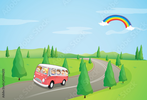 A bus with kids running along the curve road