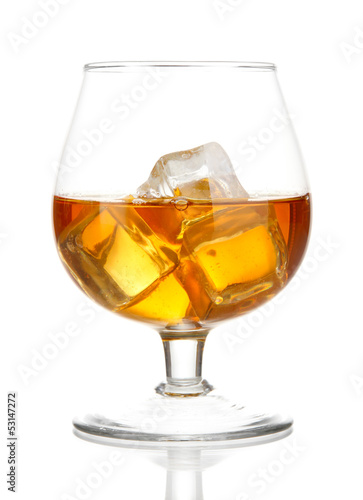 Brandy glass with ice isolated on white © Africa Studio