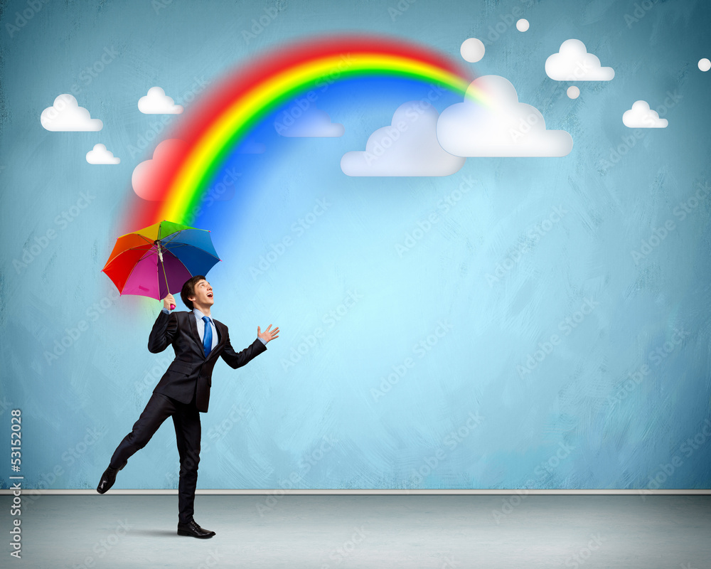 Businessman with umbrella atop of building Businessman with umbrella atop of building