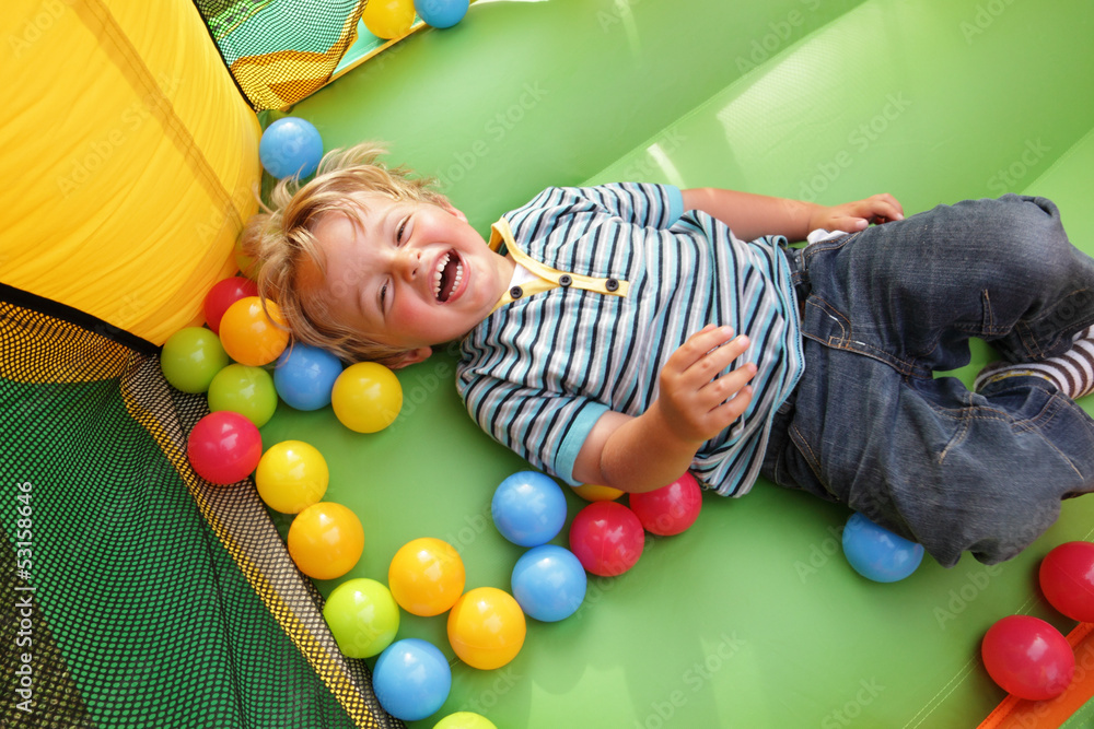 Obraz premium Child on inflatable bouncy castle