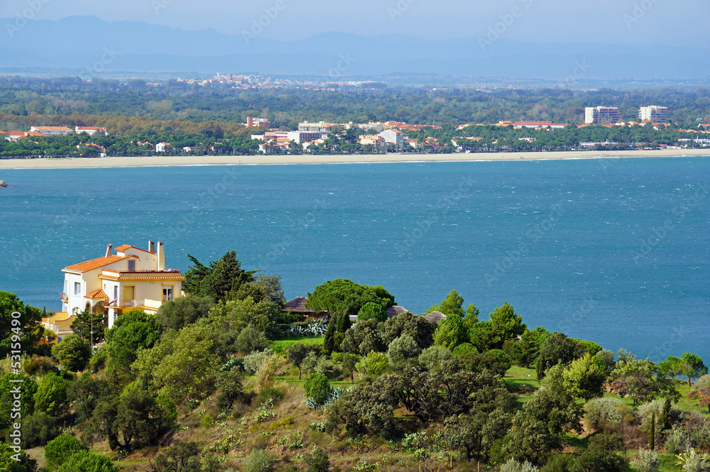 Villa above the Mediterranean sea with the town of Argeles sur Mer in background, Roussillon, Pyrenees Orientales, France