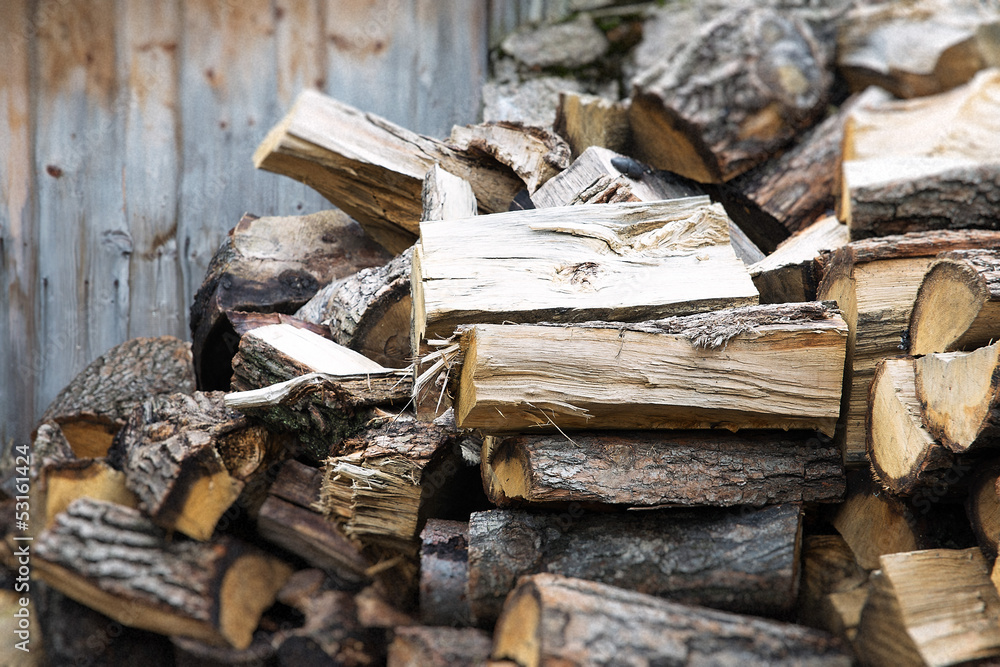 Stacked chopped wood for the winter or construction Stacked chopped wood for the winter or construction