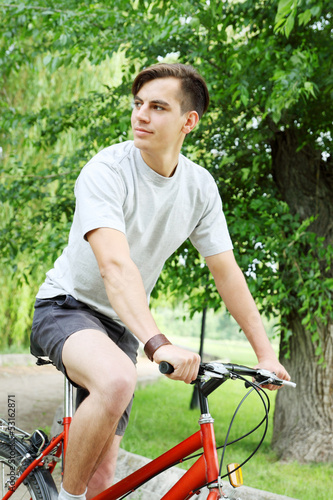 young man riding a bike © Mallivan