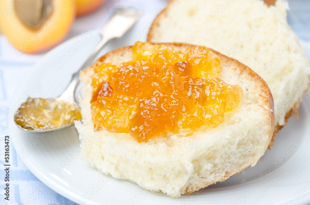 Sweet bun with apricot jam close-up Sweet bun with apricot jam close-up