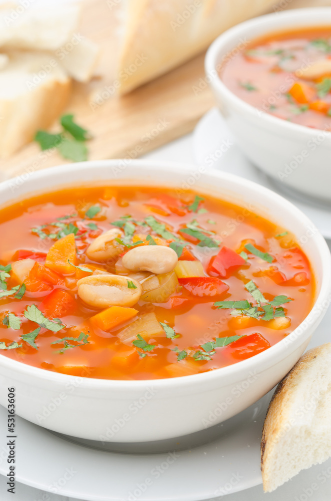 Vegetable soup with white beans in a bowl closeup