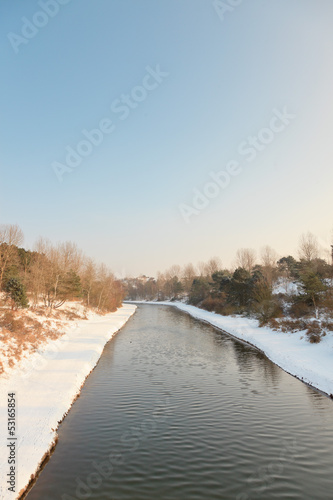 Winter landscape with canal and blue sky. The Netherlands. © ysbrandcosijn