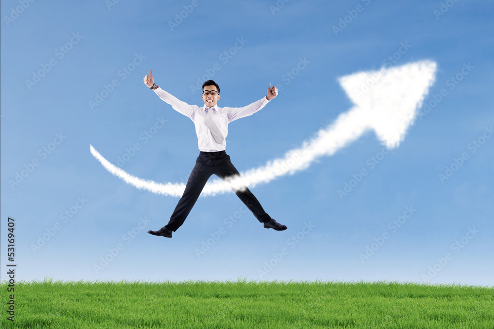 Businessman jumping and give thumbs up over success sign Businessman jumping and give thumbs up over success sign