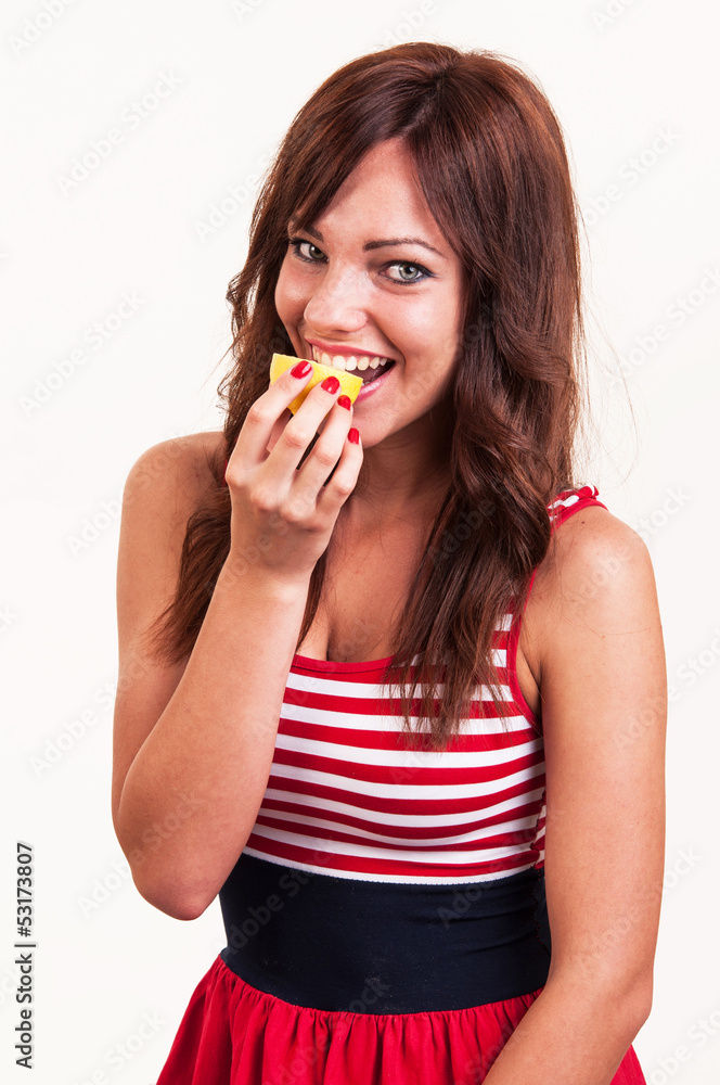 Portrait of beautiful young woman, she eating fresh lemon Portrait of beautiful young woman, she eating fresh lemon