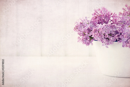 Fototapeta Naklejka Na Ścianę i Meble -  Purple lilac spring flowers on vintage textured background