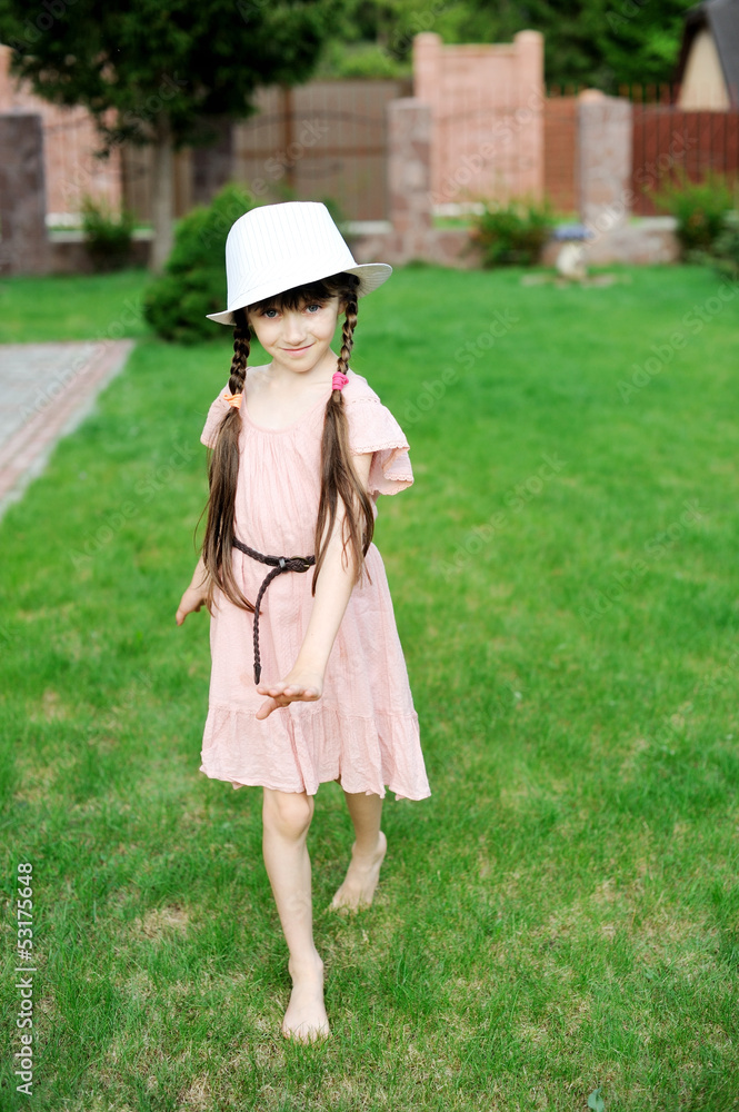 Amazing little girl in pink dress and white hat