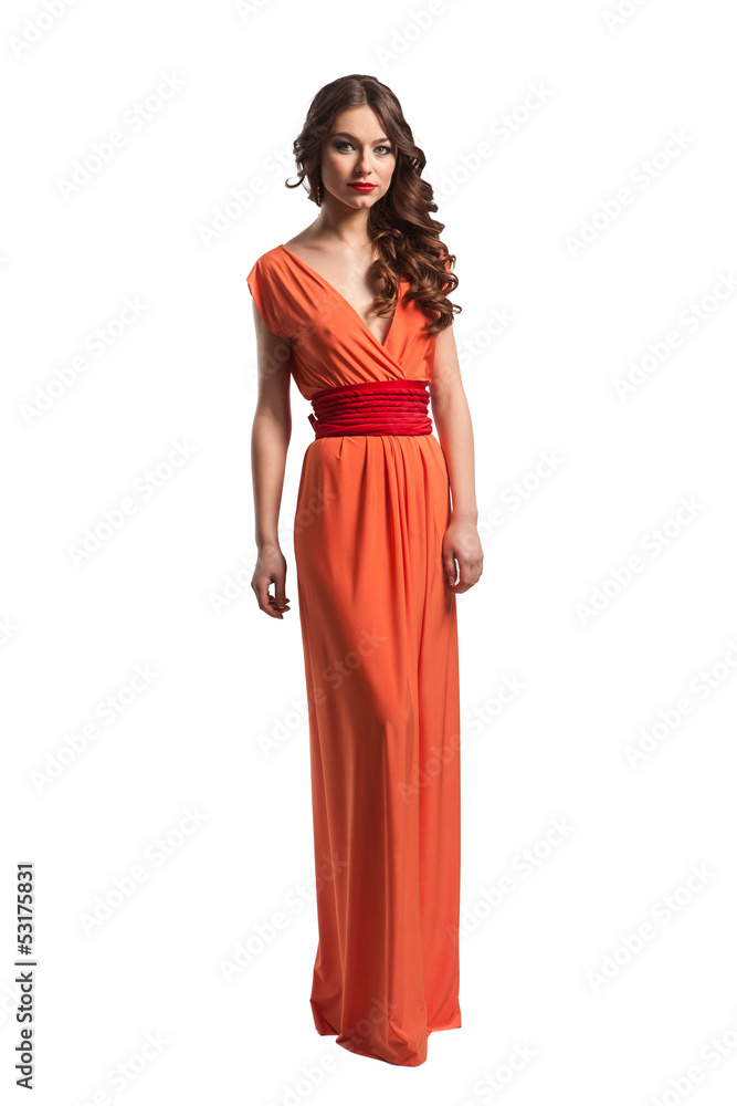 Model with beautiful long hair posing in orange dress isolated