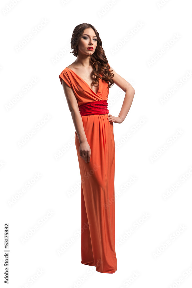 Model with beautiful long hair posing in orange dress isolated Model with beautiful long hair posing in orange dress isolated