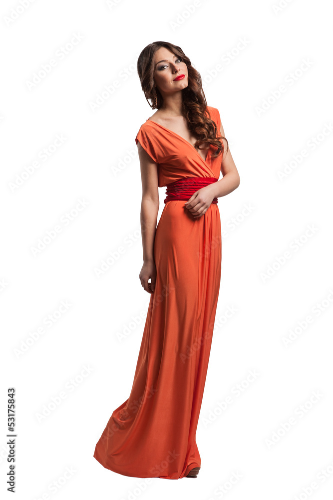 Model with beautiful long hair posing in orange dress isolated