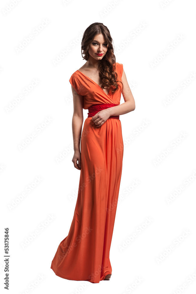 Model with beautiful long hair posing in orange dress isolated