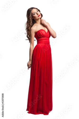 Beautiful female fashion model posing in red dress